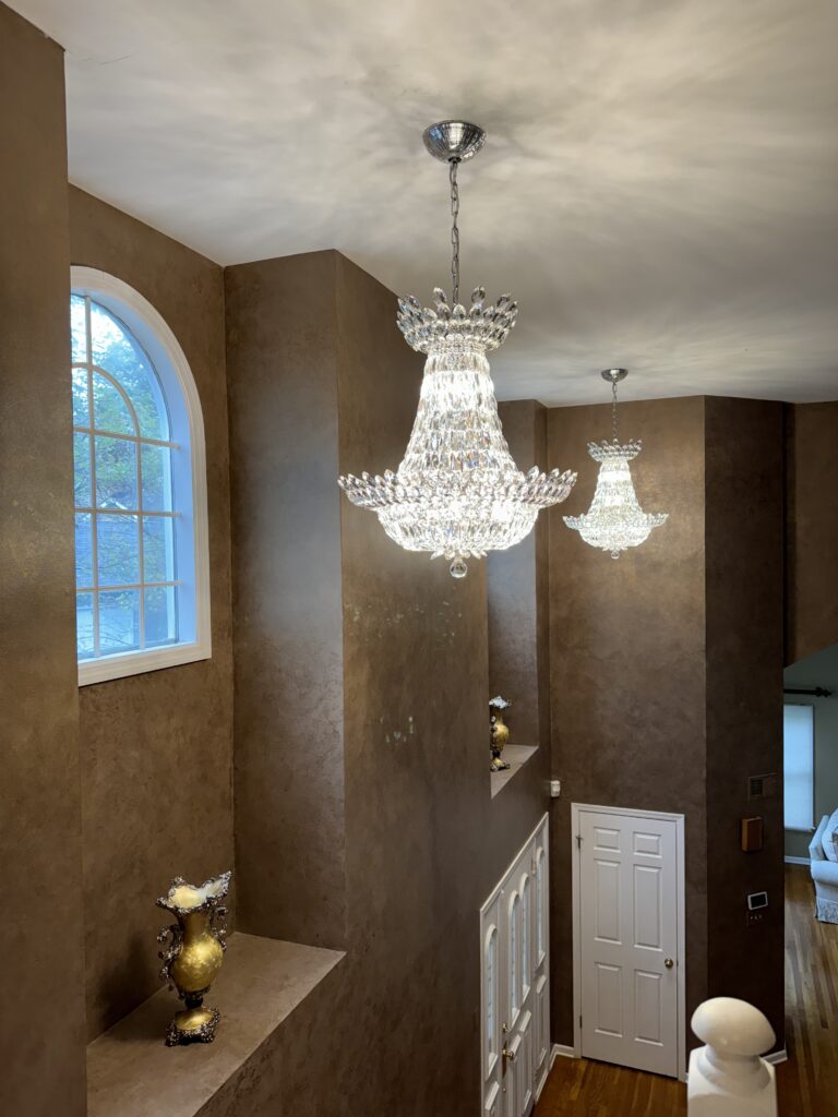 Crystal chandelier installed in a two story entry