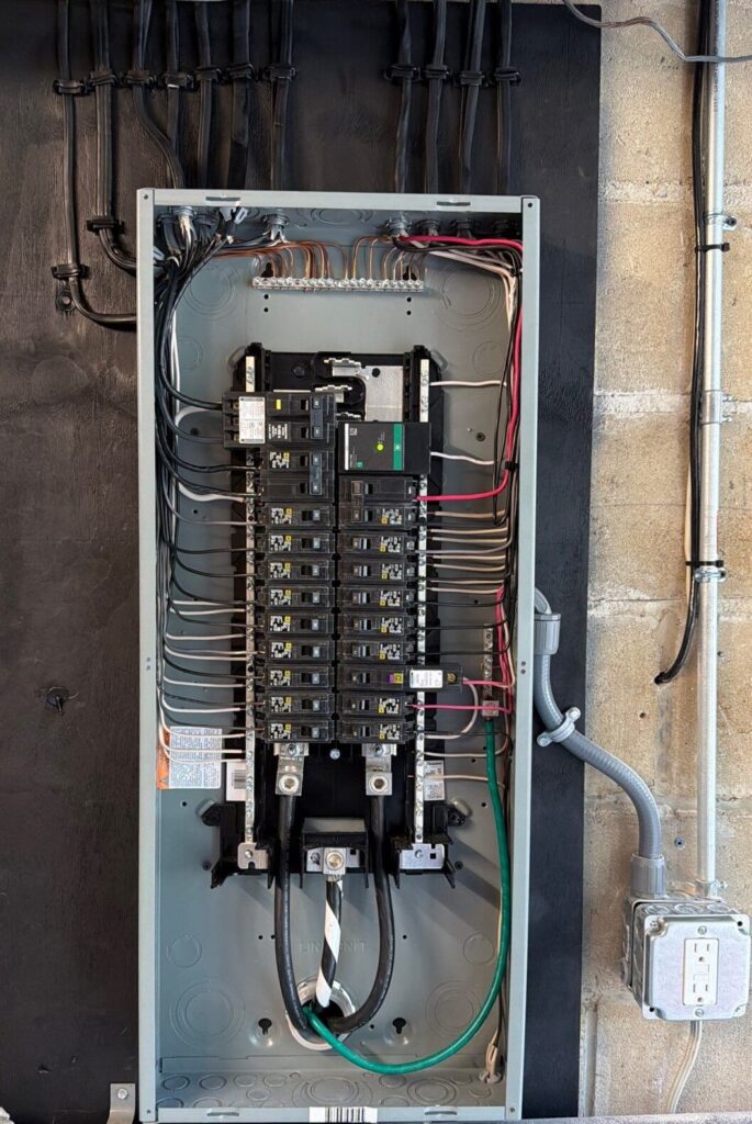 Square D electrical panel with new breakers, neat wiring and a surge protector after a panel upgrade for a Westfield, NJ area home