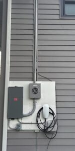 Outdoor EV charger installed beside the meter by Spartan Home Pros