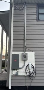 Outdoor EV charger and meter main installed by Spartan Home Pros