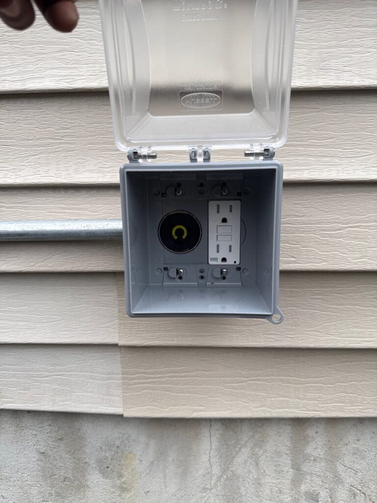 Weatherproof Hubbell box housing a generator inlet on the outside wall of a New Jersey home