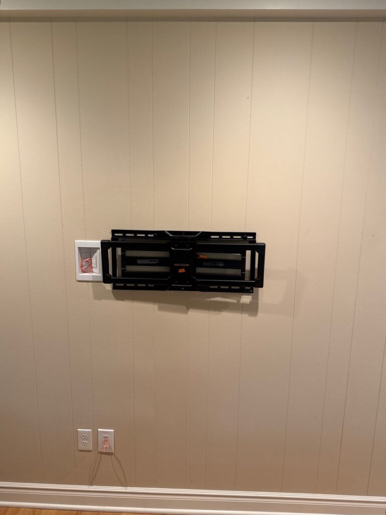 New outlet installed behind a wall mounted television
