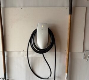 Level 2 EV charger mounted on a garage wall by Spartan Home Pros