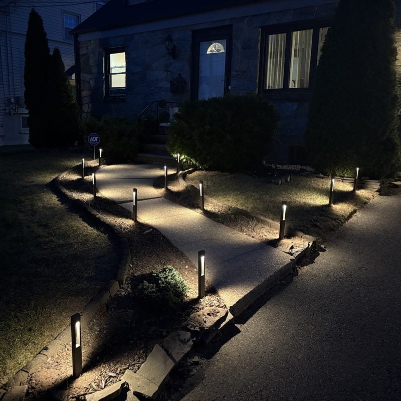 Landscape path lights along a curved front walkway in New Jersey, installed by Spartan Home Pros