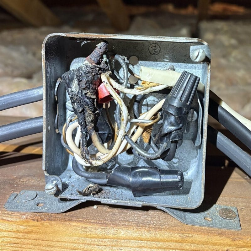 Old burned wiring found in an attic box in a New Jersey home by Spartan Home Pros