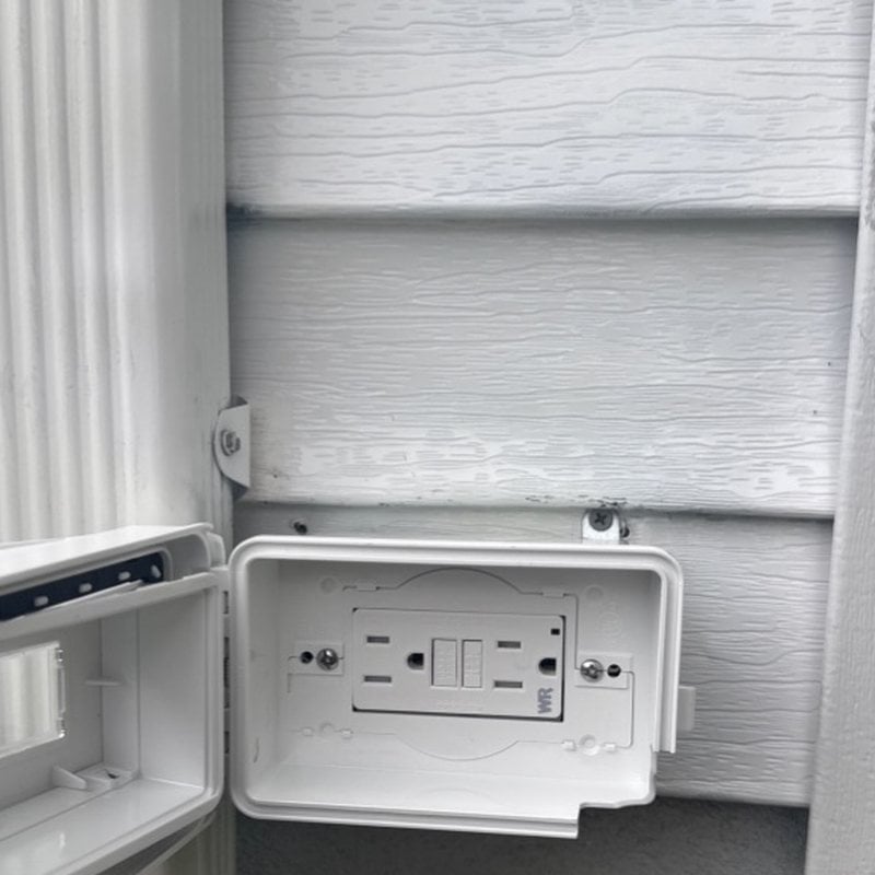 New weatherproof GFCI outdoor outlet installed by Spartan Home Pros after a burned outlet