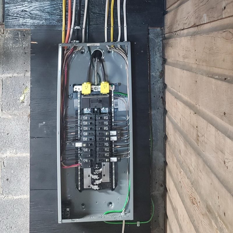 New breaker panel with neatly run wiring, installed by Spartan Home Pros
