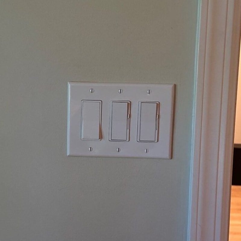 Three switches and a dimmer in one neat wall plate, installed in a New Jersey home by Spartan Home Pros